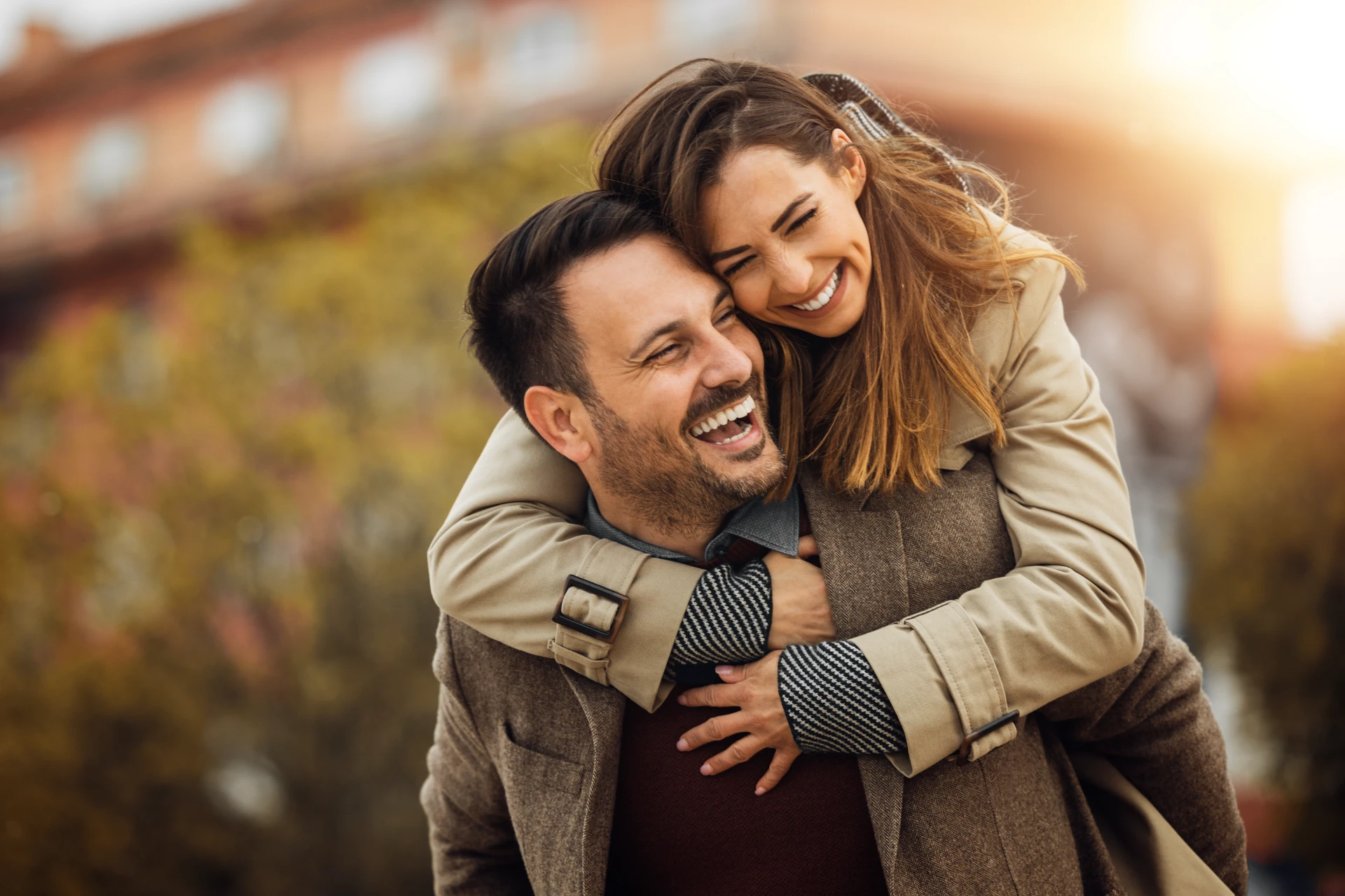 Loving young couple hugging and smiling together outdoors.