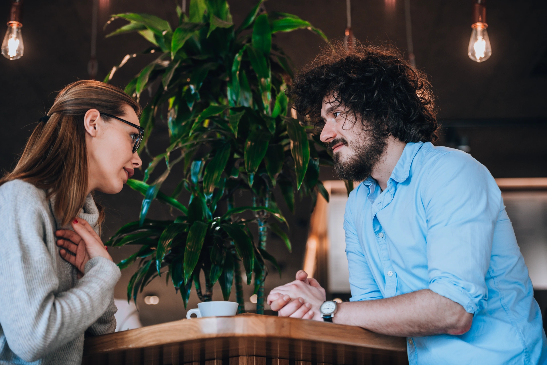 Beautiful romantic pair hanging out, laughing and drinking coffee