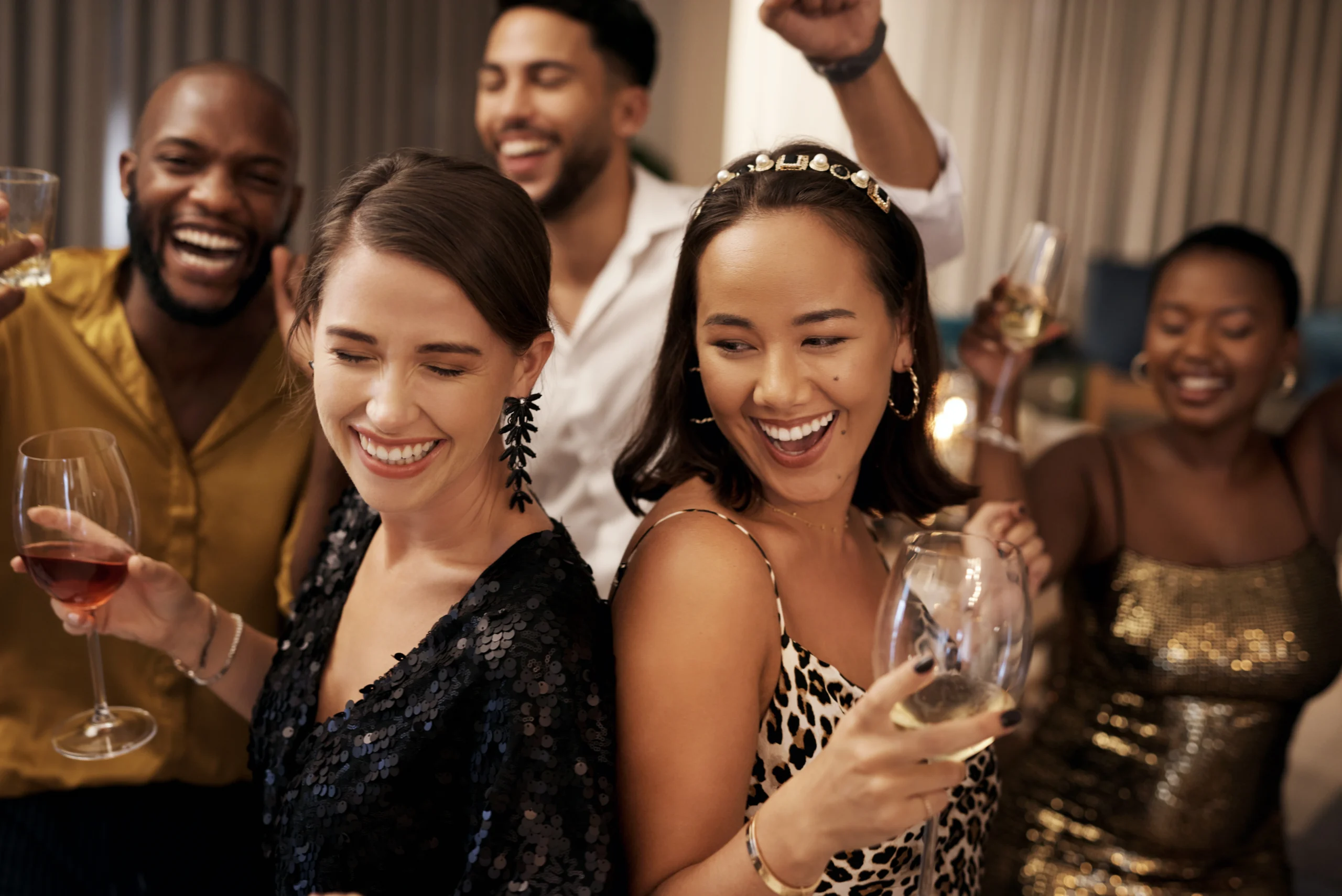 We plan on dancing the whole night. Shot of a diverse group of friends dancing during a New Years party at home.